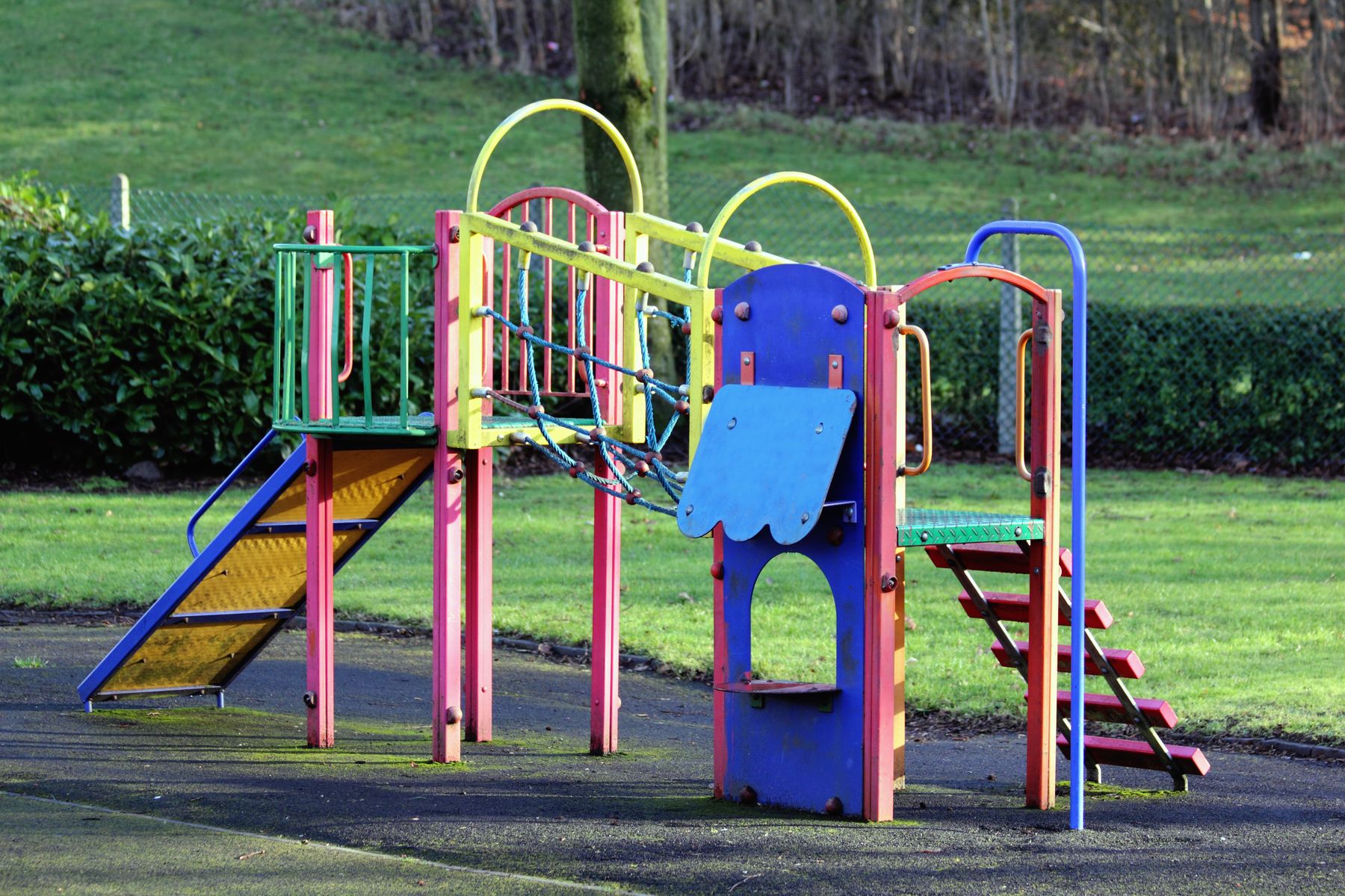 A completed neighborhood playground in a grassy park